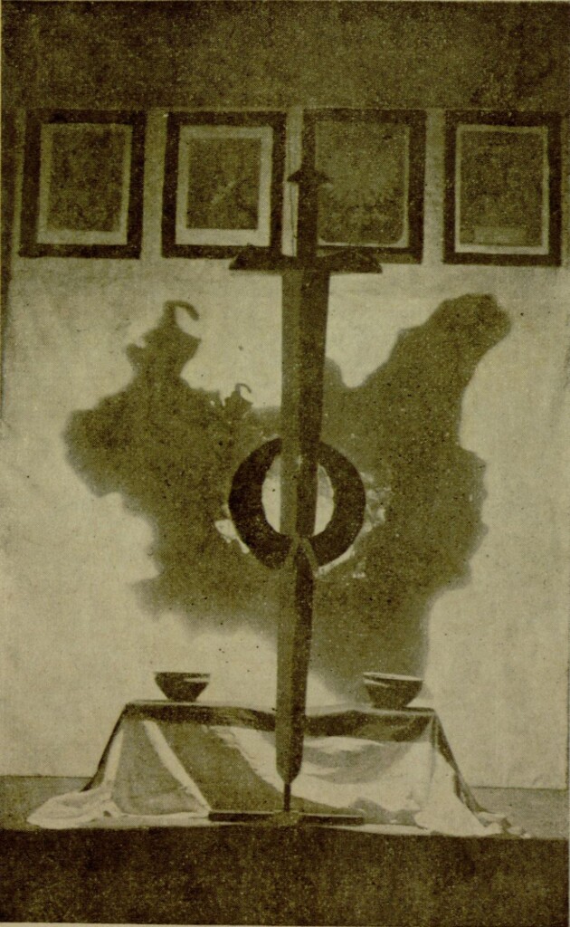 cztery portrety, pod nimi kontur Polski z granicami z lat 1918-1939, ołtarz z dwoma zniczami i wbity pionowo miecz