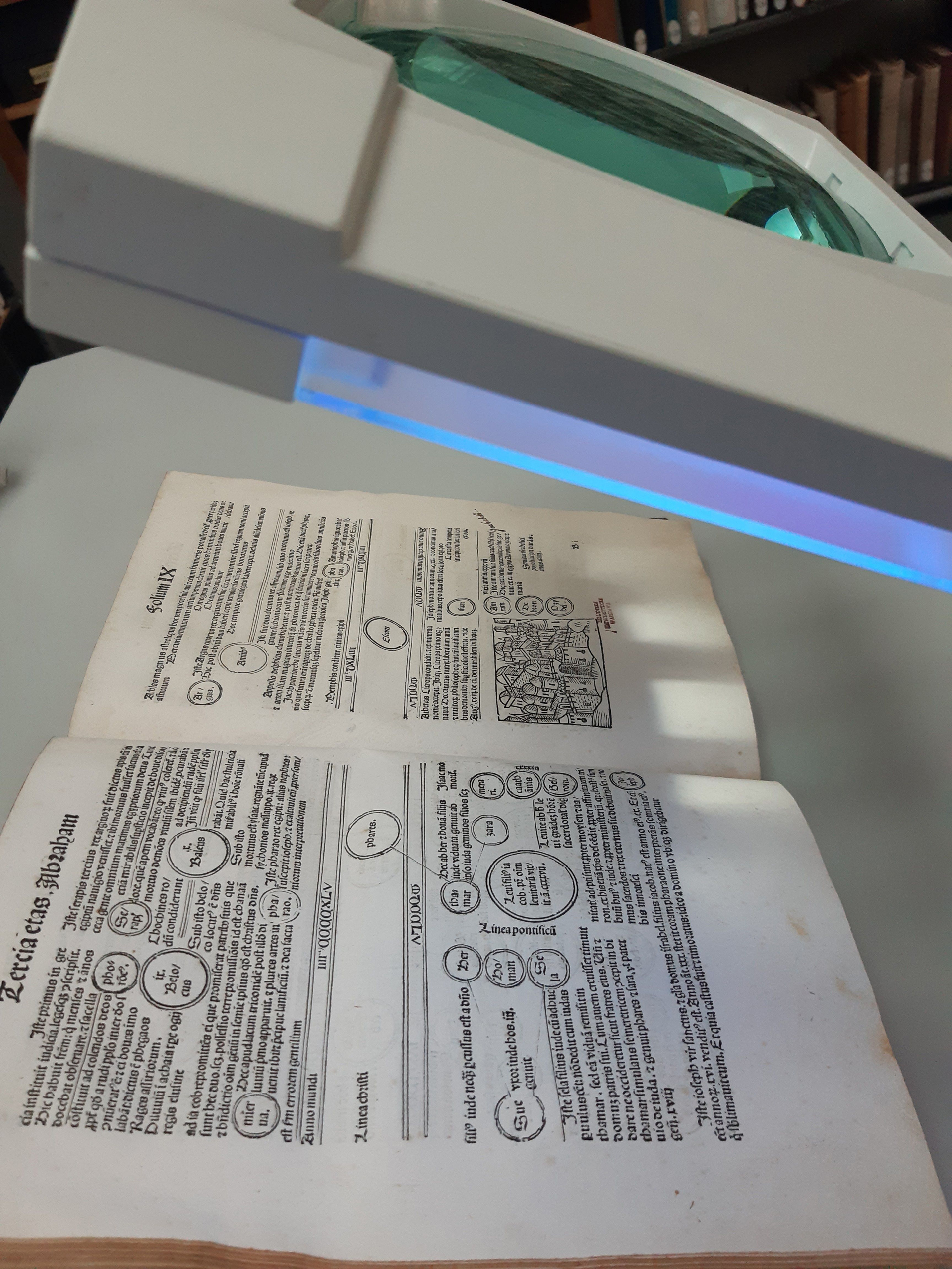 Stary druk leżący pod lampą UV.